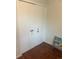 A closet with white doors and decor on the doors, showing hardwood flooring and a bookcase at 8452 Everett Way # C, Arvada, CO 80005