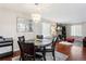 Dining area with chandelier, hardwood floors, open to living room at 8452 Everett Way # C, Arvada, CO 80005