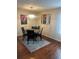 Dining room with hardwood floors, a chandelier, and seating for four at the dining table at 8452 Everett Way # C, Arvada, CO 80005