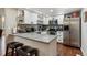 Well-lit kitchen with stainless steel appliances, granite countertops, and breakfast bar at 8452 Everett Way # C, Arvada, CO 80005