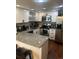Well-lit kitchen with white cabinets, stainless steel appliances, and granite countertops at 8452 Everett Way # C, Arvada, CO 80005