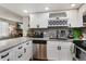 Kitchen with stainless steel appliances, granite countertops, and patterned backsplash at 8452 Everett Way # C, Arvada, CO 80005
