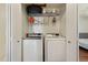 Functional laundry closet with washer, dryer, and storage shelves at 8452 Everett Way # C, Arvada, CO 80005