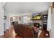 Cozy living room with hardwood floors and stone fireplace, open to dining area at 8452 Everett Way # C, Arvada, CO 80005