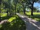Scenic pathway through a tree-lined park with bench at 8452 Everett Way # C, Arvada, CO 80005