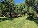 Community playground with green grass and mature trees at 8452 Everett Way # C, Arvada, CO 80005