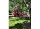Colorful playground in a grassy park setting with mature trees at 8452 Everett Way # C, Arvada, CO 80005