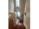 Well-lit staircase with wood steps and a modern hanging light fixture at 8452 Everett Way # C, Arvada, CO 80005