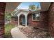 Brick ranch house with a covered entryway and landscaped walkway at 1456 S Moline St, Aurora, CO 80012