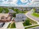 Aerial view showcasing a charming home with well-maintained landscaping and a three car garage at 16120 E 119Th Ave, Commerce City, CO 80022