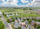 Aerial view of a home in a suburban neighborhood near green spaces and a pond at 16120 E 119Th Ave, Commerce City, CO 80022
