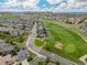 Stunning aerial view of home with golf course and park nearby in a suburban neighborhood at 16120 E 119Th Ave, Commerce City, CO 80022