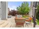 Back patio with ample seating, mature trees, and views to an outdoor space at 16120 E 119Th Ave, Commerce City, CO 80022