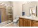 Neutral bathroom featuring a glass-enclosed shower, tiled floors, and a wood vanity with sink at 16120 E 119Th Ave, Commerce City, CO 80022