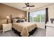 This bedroom is inviting and features dark wood floors, ceiling fan, and modern decor at 16120 E 119Th Ave, Commerce City, CO 80022