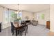Elegant dining room with large windows, a chandelier, and comfortable seating at 16120 E 119Th Ave, Commerce City, CO 80022