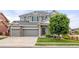 Charming two-story home featuring a three-car garage, well-maintained lawn and mature landscaping at 16120 E 119Th Ave, Commerce City, CO 80022