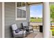 Relaxing front porch seating area with views of green space at 16120 E 119Th Ave, Commerce City, CO 80022