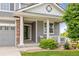 Inviting covered front porch with classic white columns and a cozy seating area at 16120 E 119Th Ave, Commerce City, CO 80022