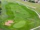 Expansive view of the well-manicured green golf course, featuring lush grass and sand traps at 16120 E 119Th Ave, Commerce City, CO 80022