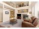 Inviting living room featuring a cozy fireplace, soaring ceilings, and an open layout with a comfortable leather chair at 16120 E 119Th Ave, Commerce City, CO 80022