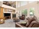 Inviting living room featuring a fireplace, soaring ceilings and plenty of natural light at 16120 E 119Th Ave, Commerce City, CO 80022