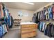 Large walk-in closet with lots of storage, shelves for shoes, and a center island for organization at 16120 E 119Th Ave, Commerce City, CO 80022