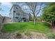 Sprawling green backyard featuring a two-story home with a deck and manicured garden beds at 1874 Cedaridge Cir, Superior, CO 80027