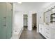 Bright bathroom with a glass-enclosed shower, soaking tub, and updated vanity at 1874 Cedaridge Cir, Superior, CO 80027