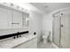 Bright bathroom with updated vanity, mirror, and glass shower door in a modern-style residential home at 1874 Cedaridge Cir, Superior, CO 80027