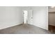 Bedroom with neutral carpet, white walls, and an open door to the hallway at 1874 Cedaridge Cir, Superior, CO 80027