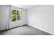 Bright bedroom with a large window offering natural light and plush carpeting at 1874 Cedaridge Cir, Superior, CO 80027