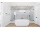 Bright, modern bathroom with a freestanding tub and a large glass enclosed shower featuring dual shower heads at 3530 Fenton St, Wheat Ridge, CO 80212