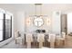 Chic dining room with unique lighting, decorative wallpaper, and seating for six at 3530 Fenton St, Wheat Ridge, CO 80212