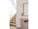 Inviting entryway featuring a staircase, modern console table, and artwork, creating a welcoming ambiance at 3530 Fenton St, Wheat Ridge, CO 80212