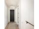 Hallway features a black door, light walls, and a neutral rug on the floor at 3530 Fenton St, Wheat Ridge, CO 80212