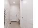 Clean hallway with white doors and neutral-colored tiled floor at 3530 Fenton St, Wheat Ridge, CO 80212