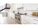 Gourmet kitchen with stainless steel appliances, white cabinets, and a modern design at 3530 Fenton St, Wheat Ridge, CO 80212