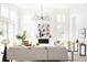 Bright living room with high ceilings, fireplace, and an abundance of natural light from large windows at 3530 Fenton St, Wheat Ridge, CO 80212