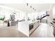 Spacious modern home with a flowing layout connecting kitchen, living, dining, and a striking staircase at 3530 Fenton St, Wheat Ridge, CO 80212