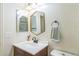 Well-lit bathroom with modern vanity, unique mirror, and decorative accents; features a cozy and functional design at 1771 W 53Rd Pl # 2, Denver, CO 80221