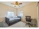 This well-lit bedroom features a daybed, ceiling fan, and a built in desk at 1771 W 53Rd Pl # 2, Denver, CO 80221