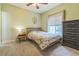 Comfortable carpeted bedroom boasts ample natural light, a ceiling fan, and dark wood dresser at 1771 W 53Rd Pl # 2, Denver, CO 80221