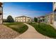 Landscaped walkway through a serene community, showcasing well-maintained buildings and common areas at 1771 W 53Rd Pl # 2, Denver, CO 80221
