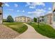 View of inviting community featuring green lawns, sidewalks, and well-maintained apartment buildings at 1771 W 53Rd Pl # 2, Denver, CO 80221