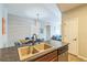 Modern kitchen featuring breakfast bar with sink, seamlessly leading to dining area at 1771 W 53Rd Pl # 2, Denver, CO 80221