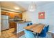 Modern kitchen features stainless steel appliances, a breakfast bar, and an adjacent dining area at 1771 W 53Rd Pl # 2, Denver, CO 80221
