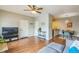 Open-concept layout with hardwood floors connects living room to dining area and kitchen at 1771 W 53Rd Pl # 2, Denver, CO 80221