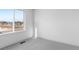 A bedroom with a view of the mountains from the window and neutral carpet at 14261 Currant St, Broomfield, CO 80020