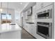 Bright, modern kitchen with stainless KitchenAid appliances, white cabinets and light wood flooring at 14261 Currant St, Broomfield, CO 80020